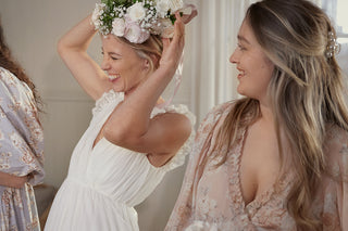 bride getting ready with bridesmaid