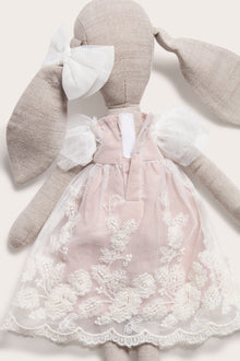 Cuddly beige toy rabbit with tutu