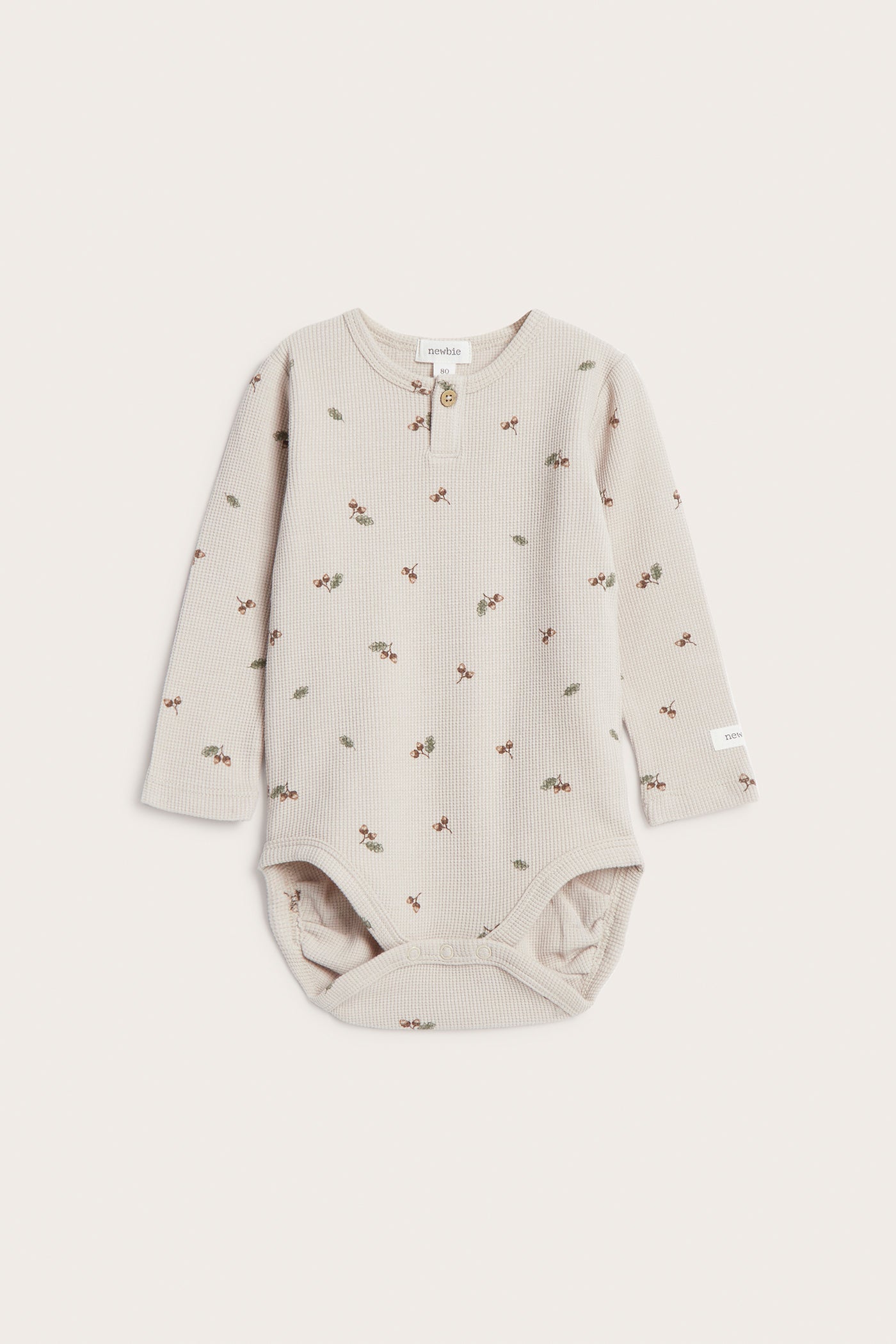 Baby beige bodysuit with acorns