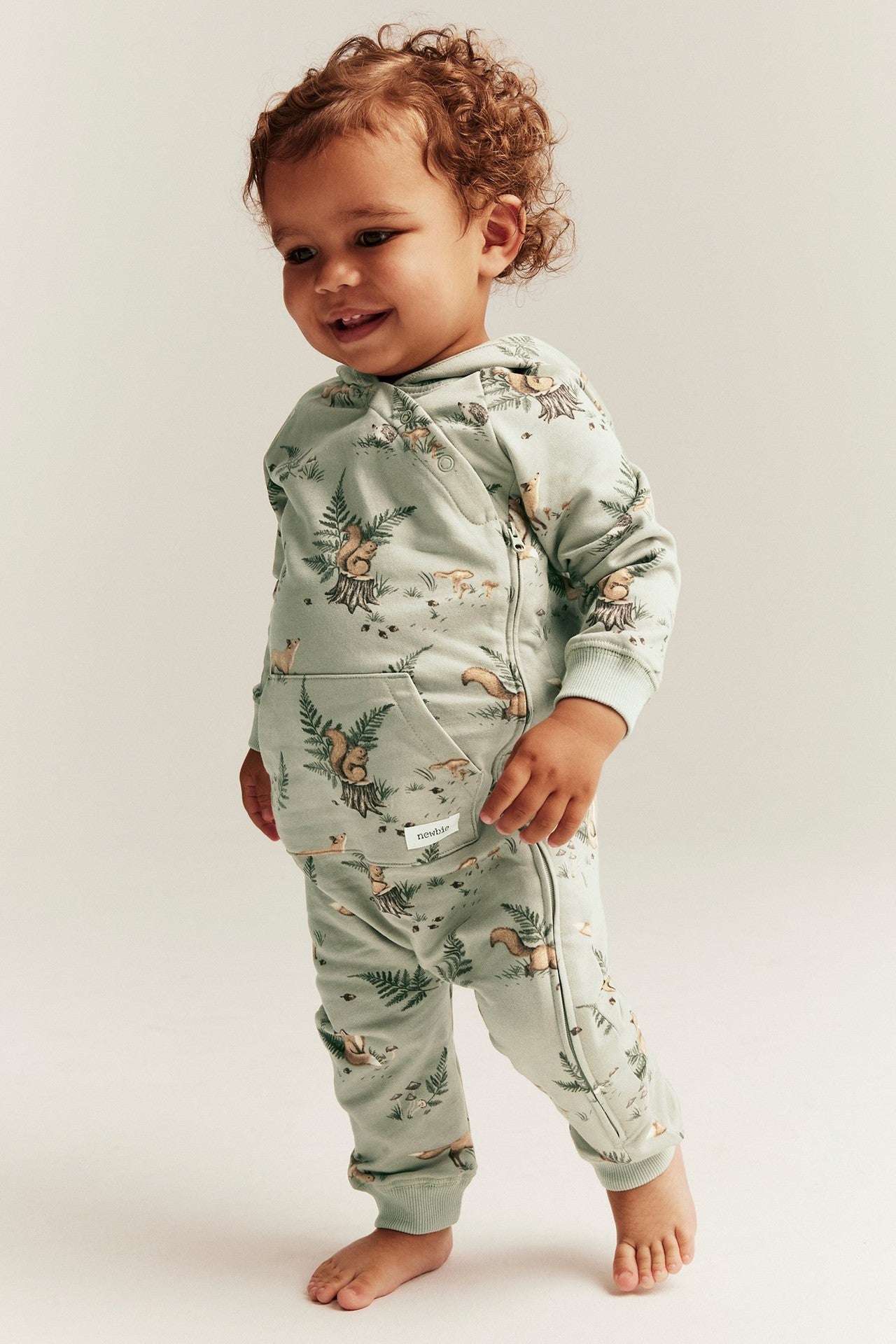 Baby green forest-patterned onesie