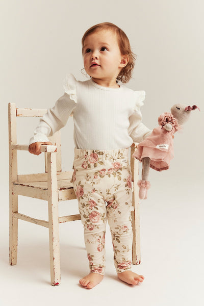 Baby white bodysuit with ruffles