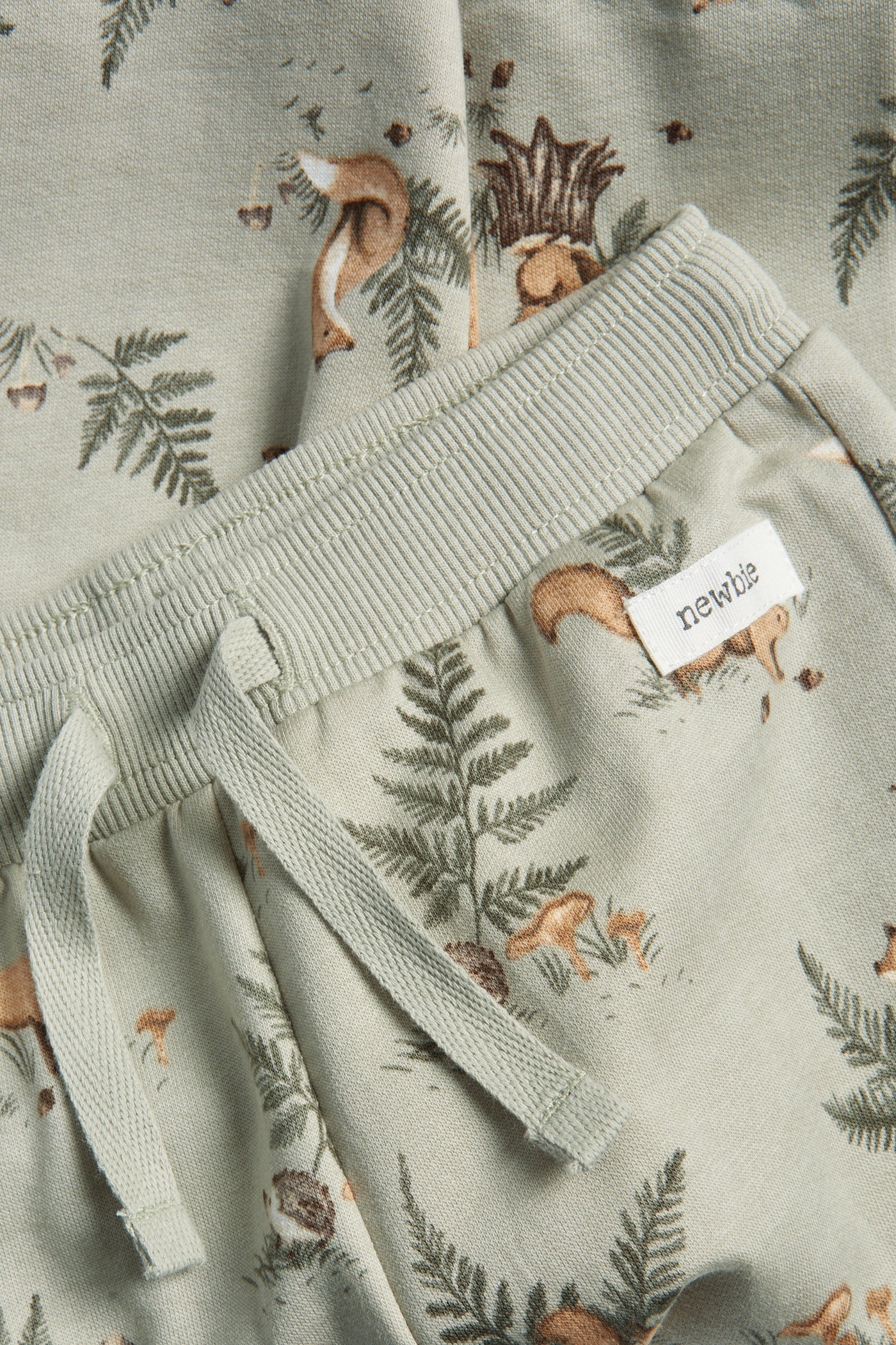 Baby green joggers with animals