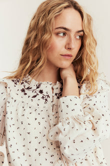 Women's beige floral blouse with frill