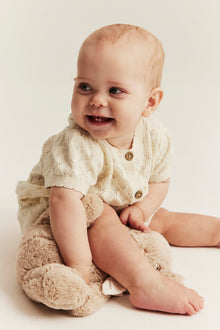 Baby beige knitted romper