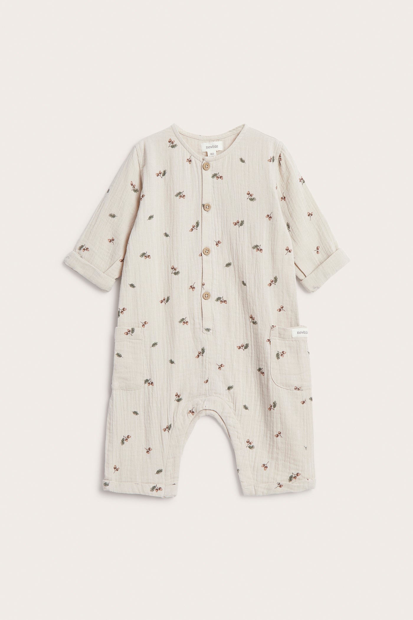 Baby beige onesie with acorns