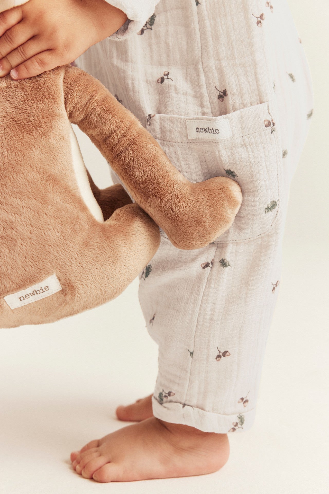 Baby beige onesie with acorns