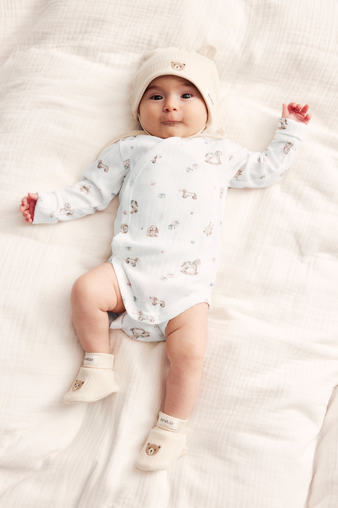 Baby white bodysuit with toys