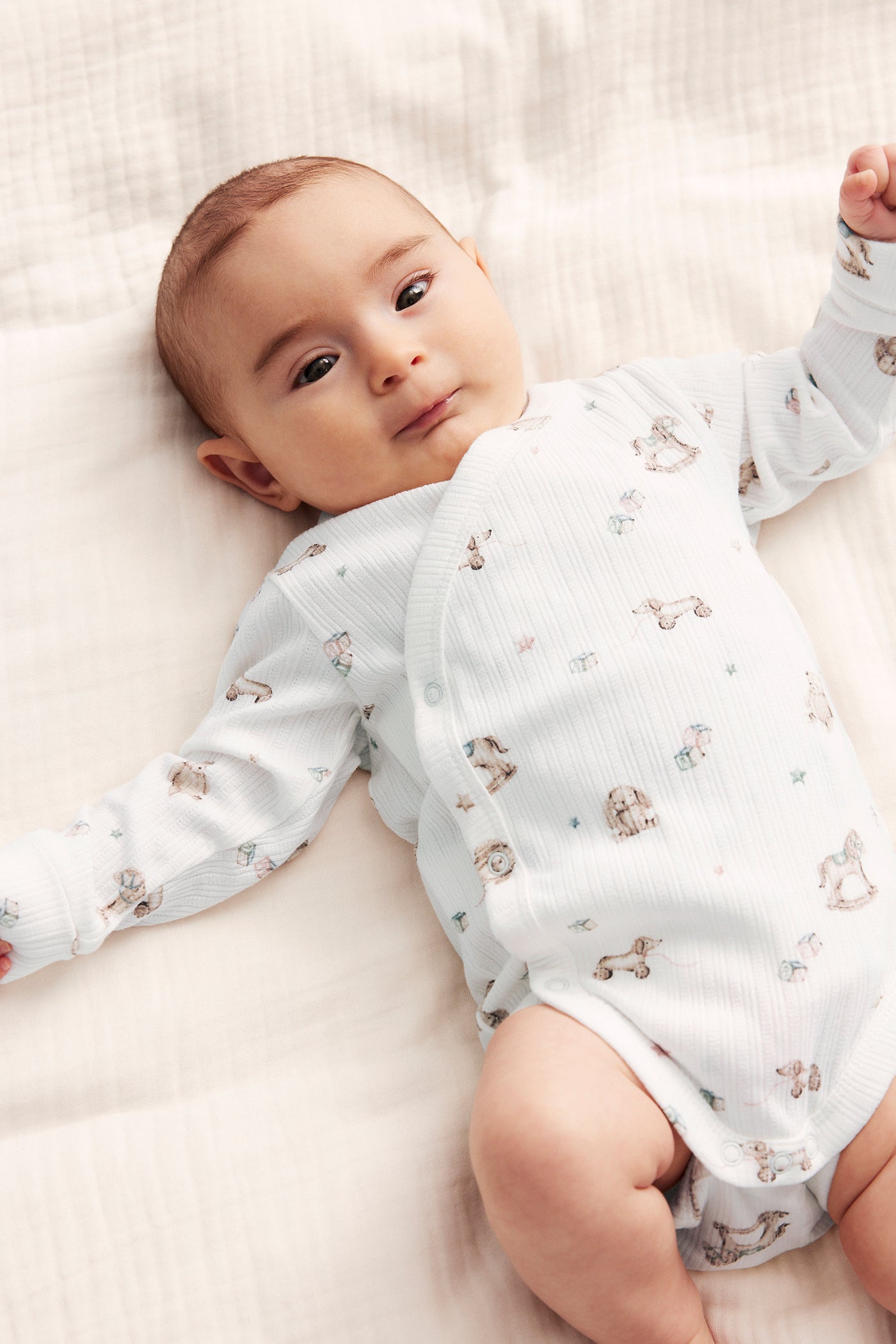 Baby white bodysuit with toys