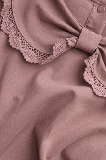 Kids' pink top with bow collar