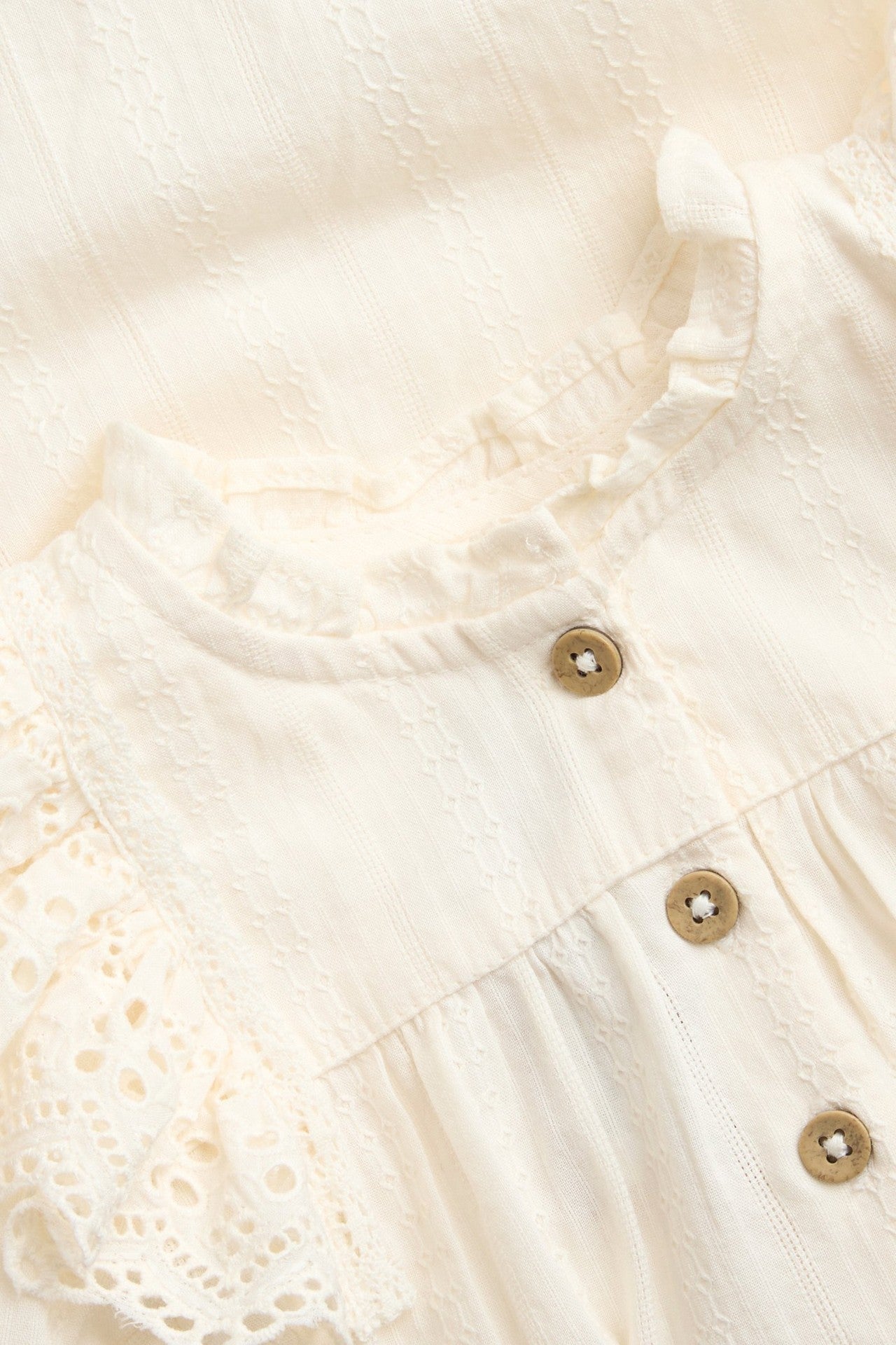 Baby white bodysuit with embroidered frills