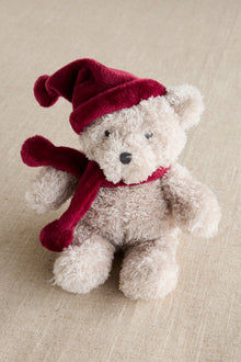 Baby red teddy bear with a Santa hat