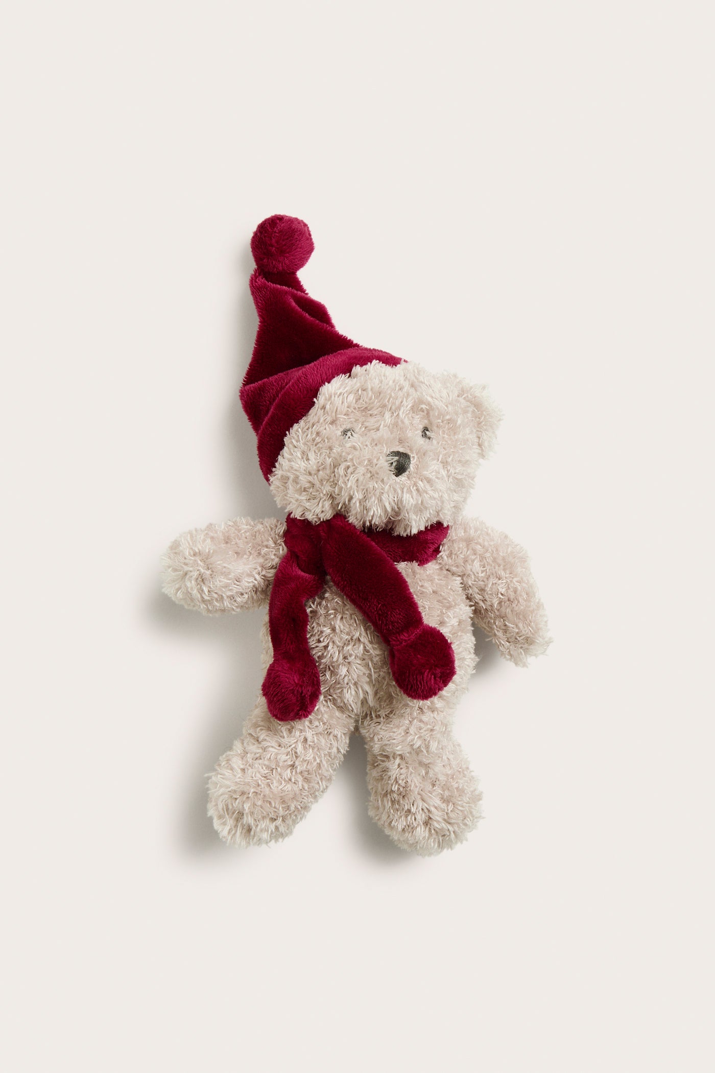 Baby red teddy bear with a Santa hat