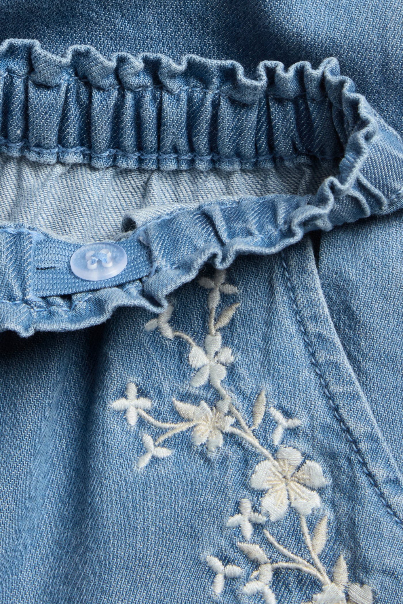 Baby blue denim trousers with floral embroidery