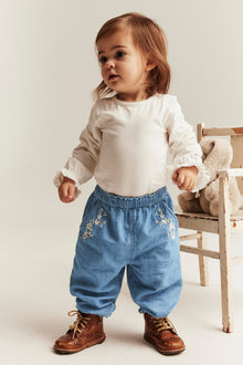 Baby blue denim trousers with floral embroidery