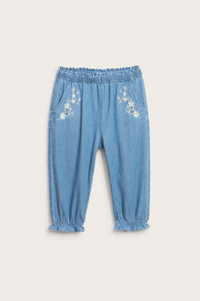 Baby blue denim trousers with floral embroidery