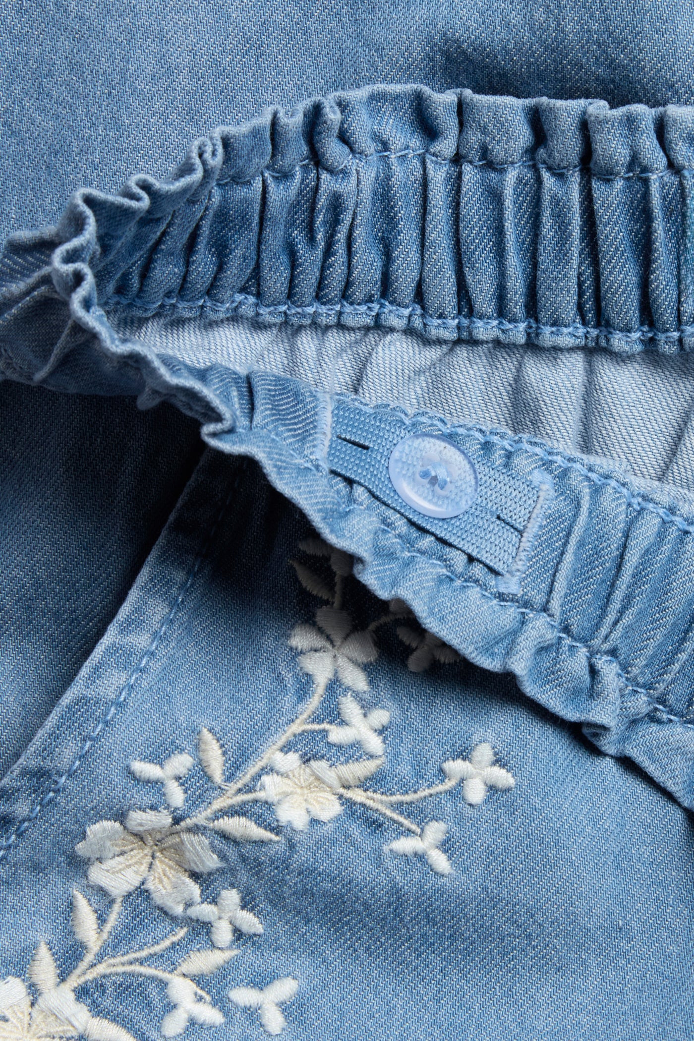 Kids blue denim trousers with floral embroidery