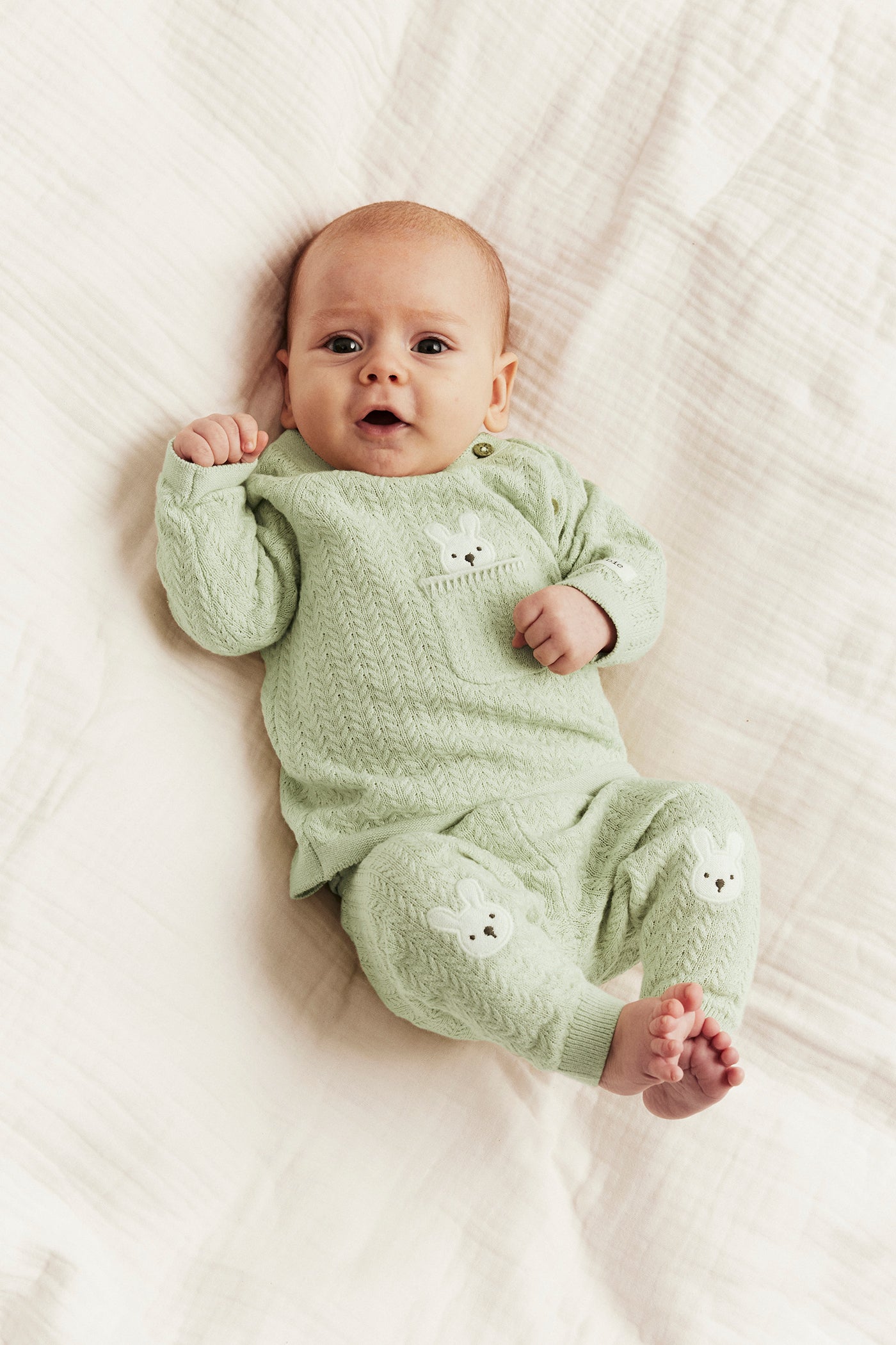 Baby green knitted cardigan with rabbit appliqué