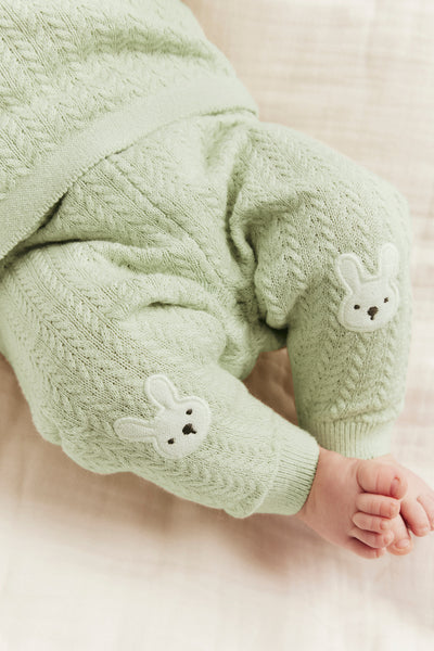 Baby green knitted leggings with rabbit appliqué
