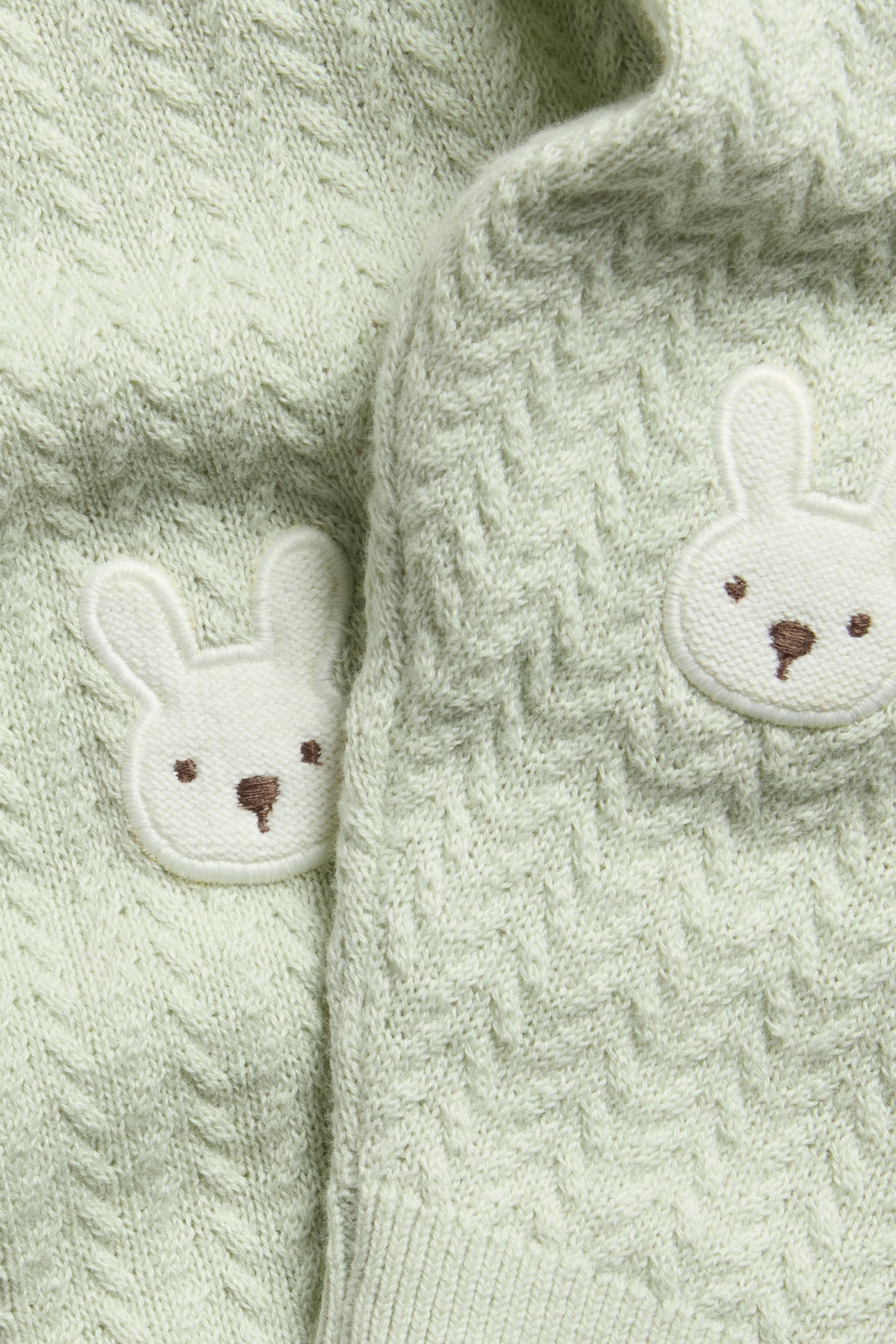 Baby green knitted leggings with rabbit appliqué