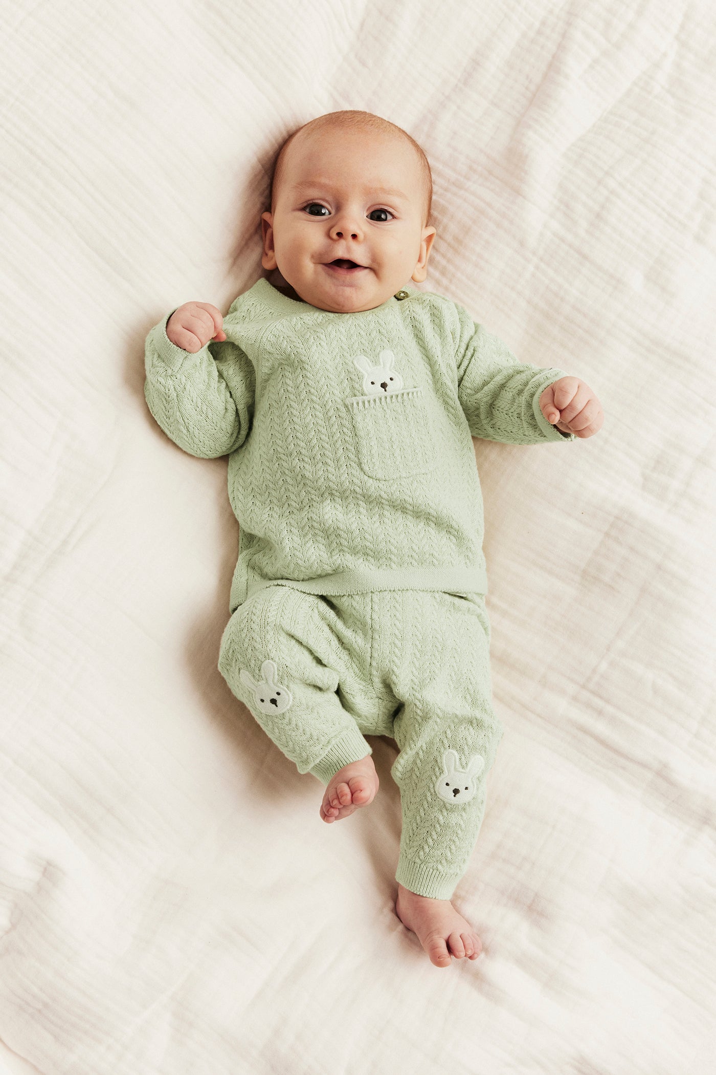 Baby green knitted leggings with rabbit appliqué