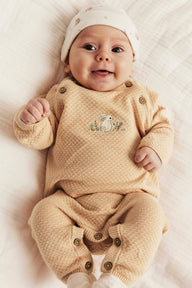 Baby orange knitted jumpsuit with embroidered rabbit