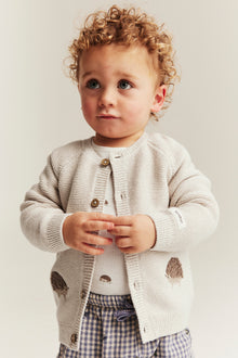 Baby beige knitted cardigan with hedgehog motif