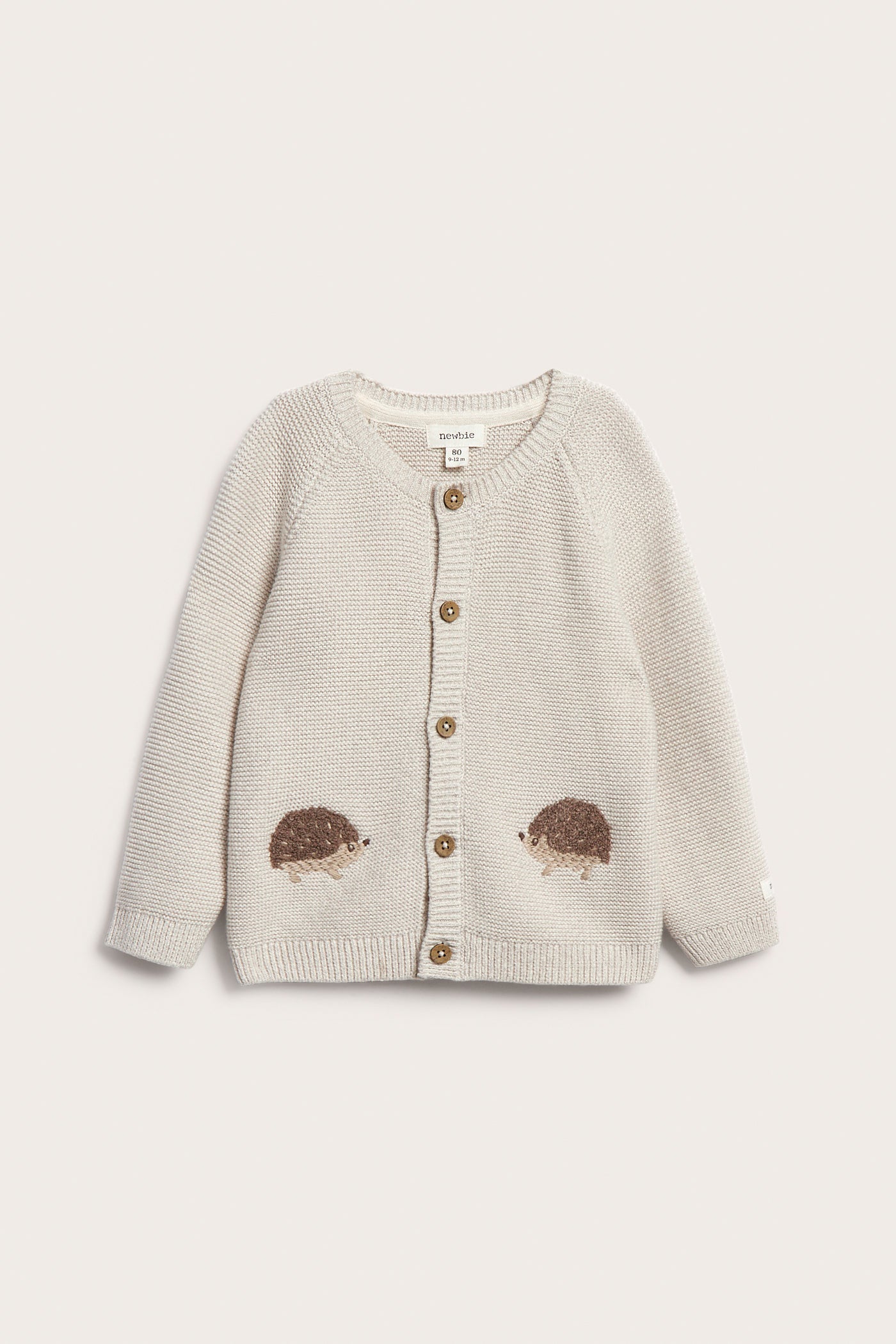 Baby beige knitted cardigan with hedgehog motif