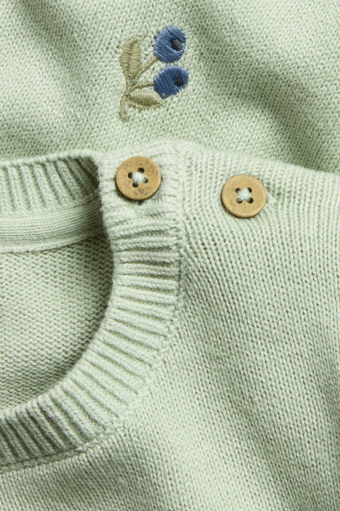 Baby green knitted jumper with blueberries