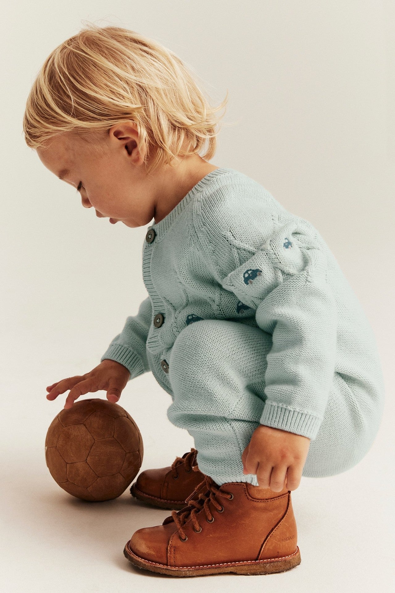 Baby green knitted jumpsuit with cars