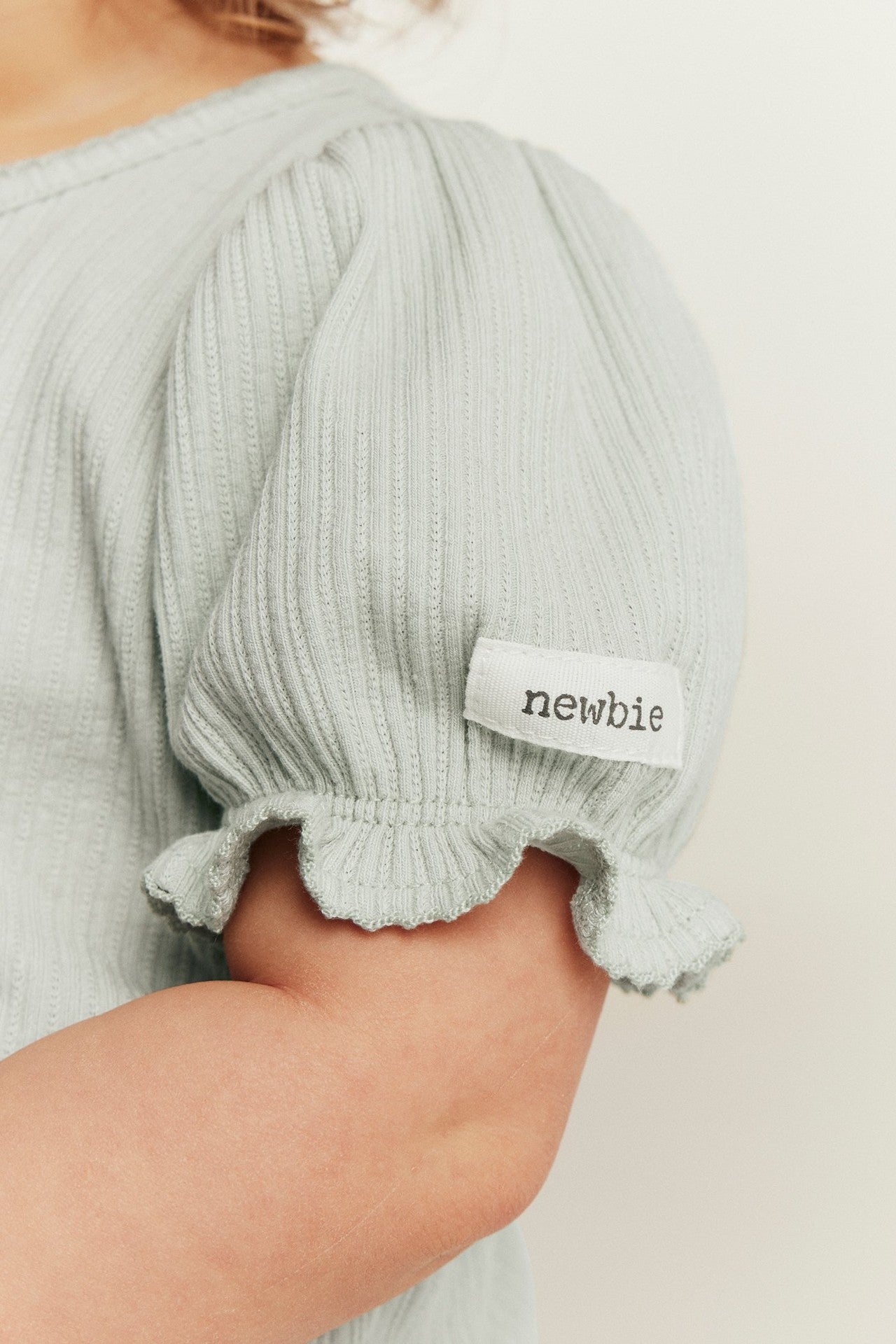 Baby green bodysuit with puff sleeves