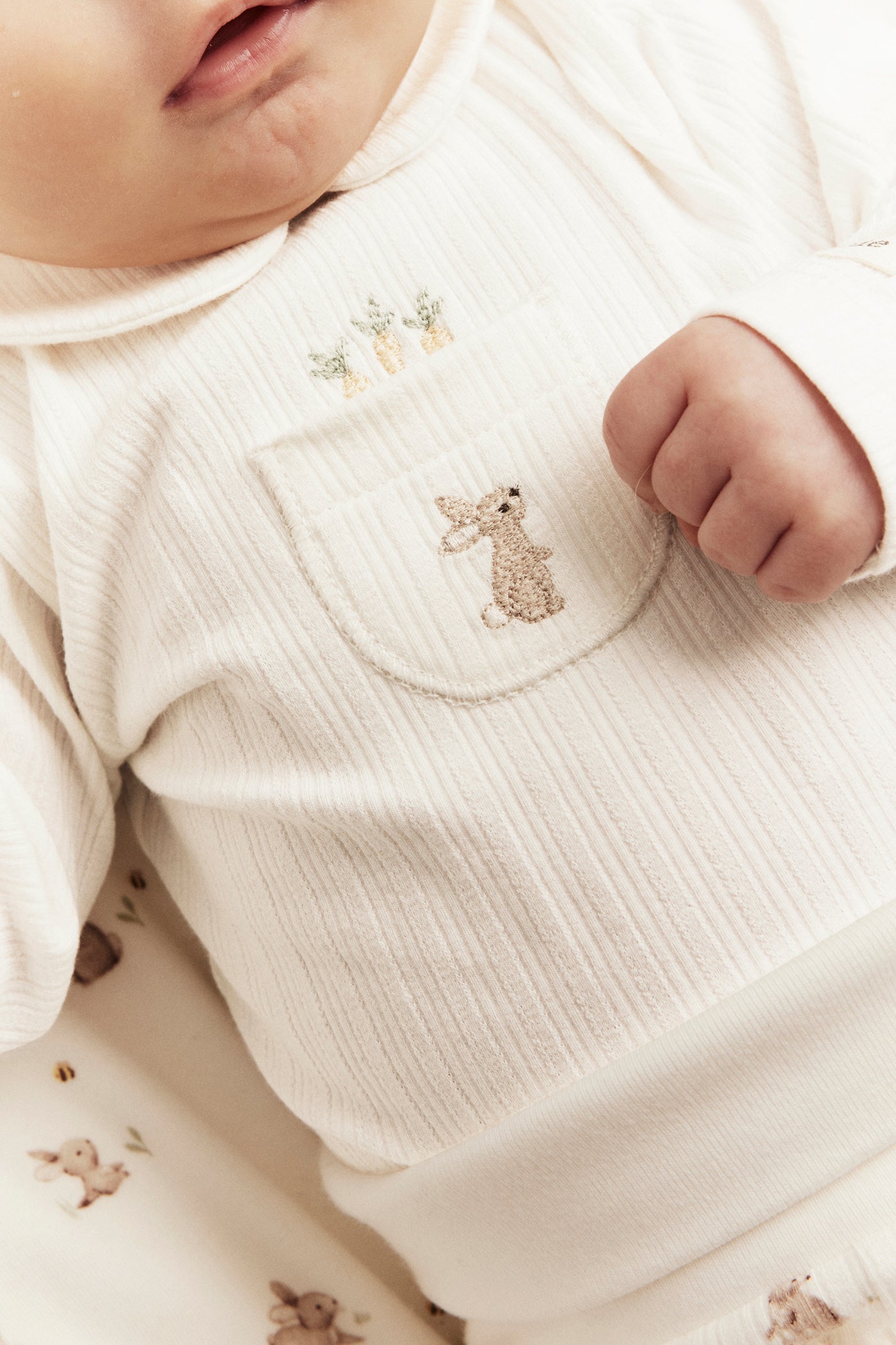 Baby white long-sleeved bodysuit with a collar