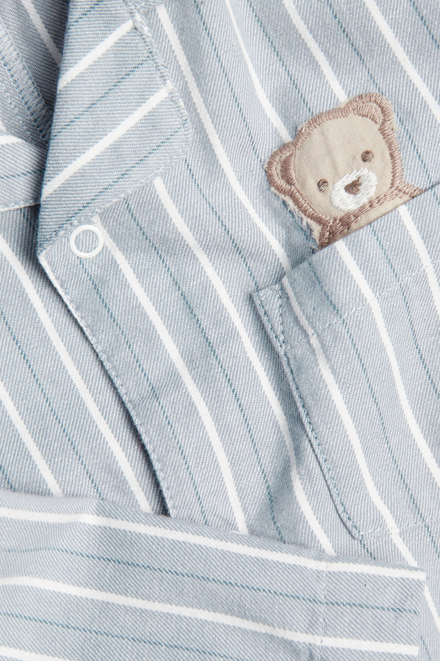 Baby blue striped sleepsuit with teddy bear