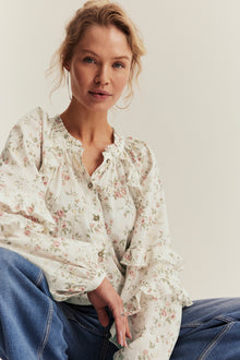 Women’s white floral blouse with frill