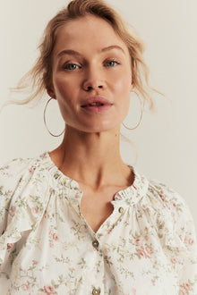 Women’s white floral blouse with frill