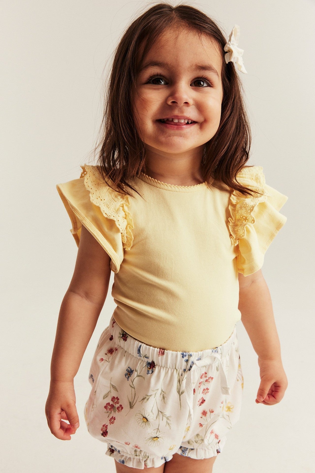 Baby yellow bodysuit with frills