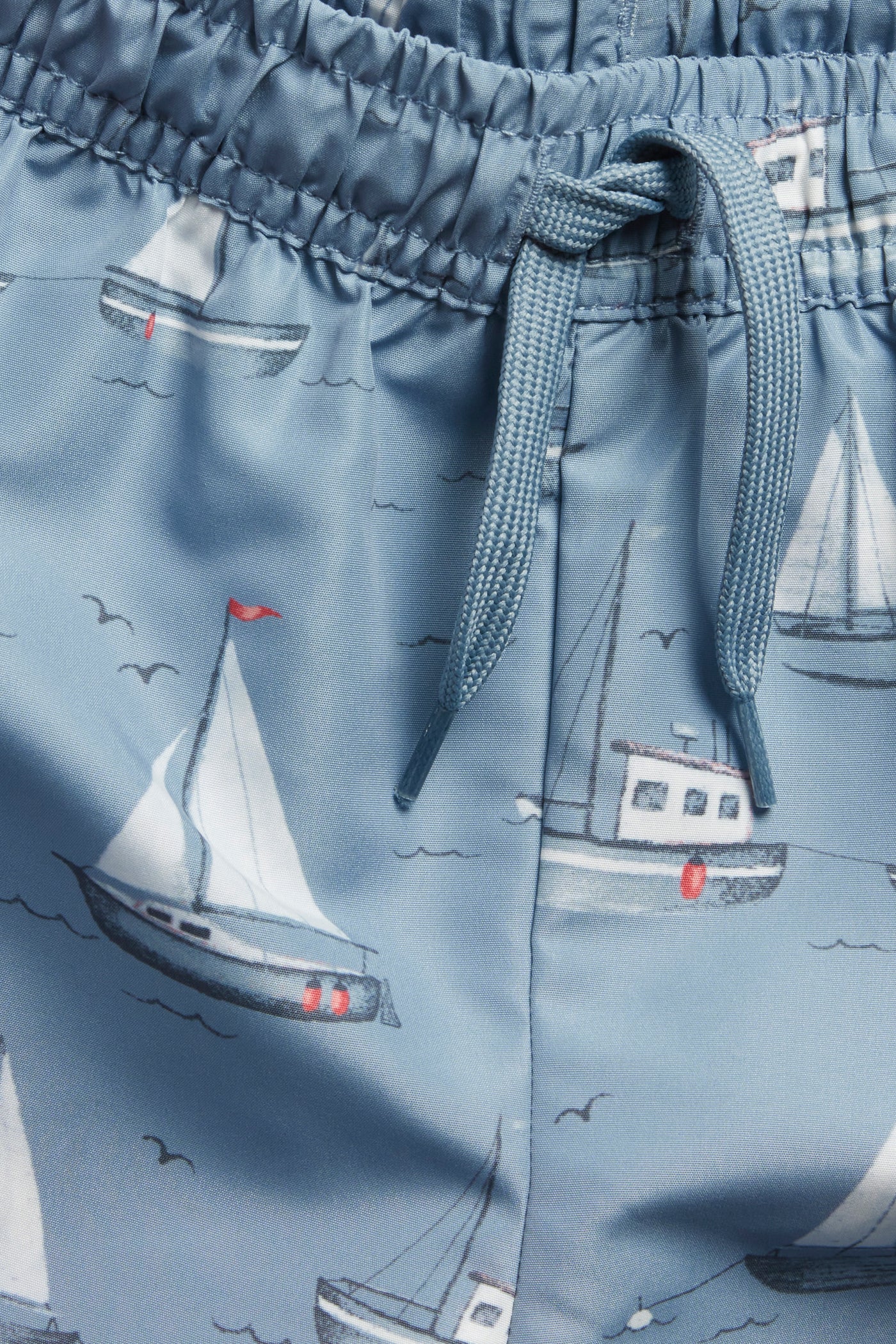 Baby & Kids’ blue swimming trunks with boat pattern