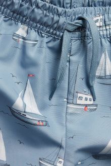 Baby & Kids’ blue swimming trunks with boat pattern