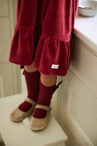 Kids´ red knee-high bow socks