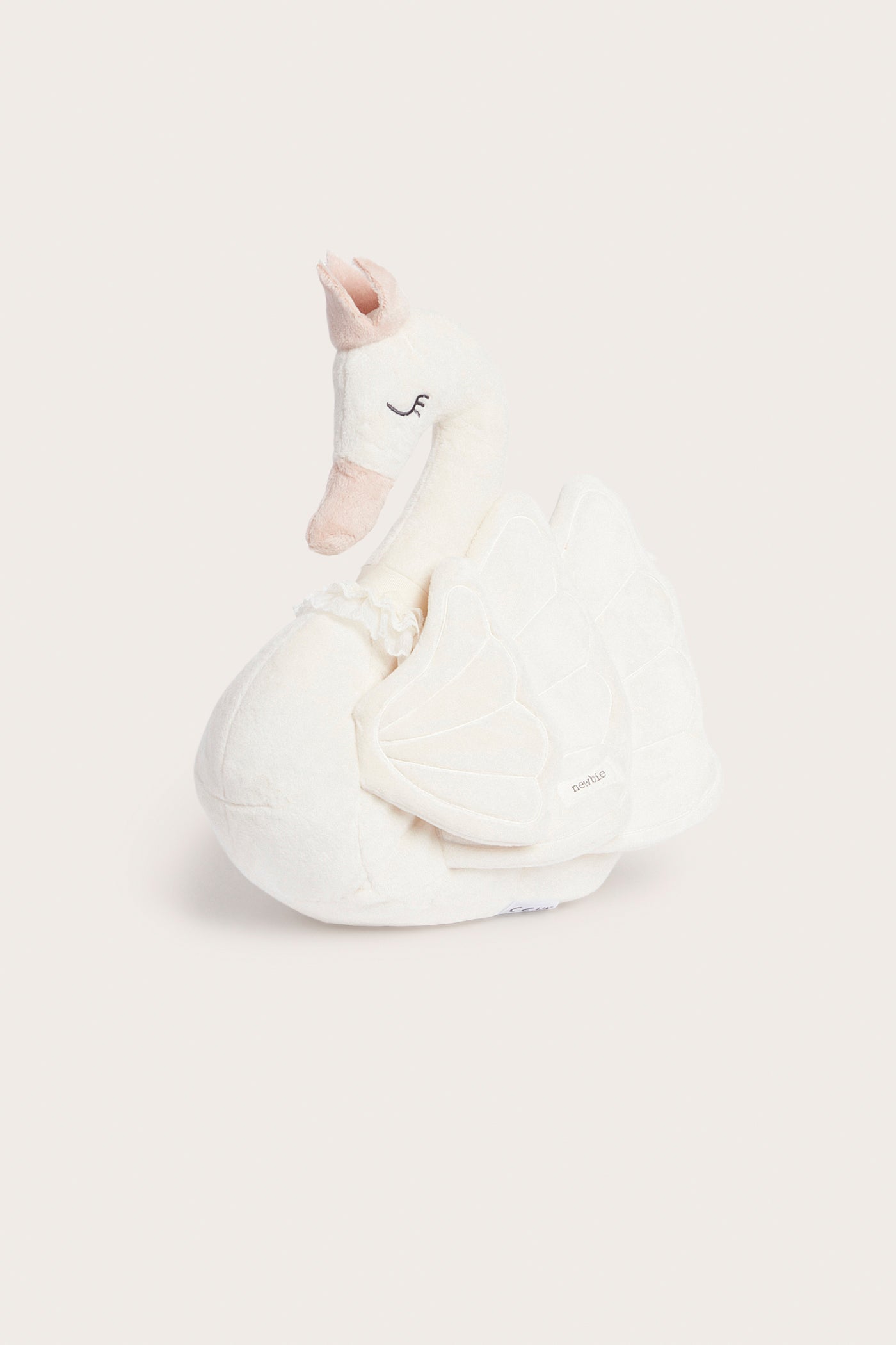 Swan‑shaped white cushion with crown