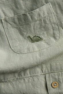 Baby green dinosaur dungarees