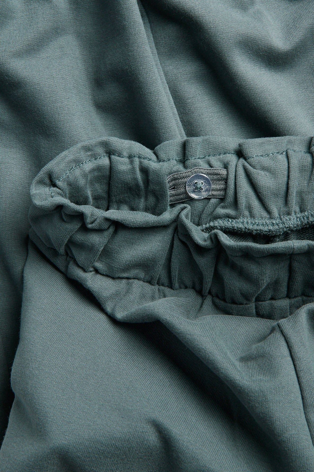 Kids green joggers with lace details
