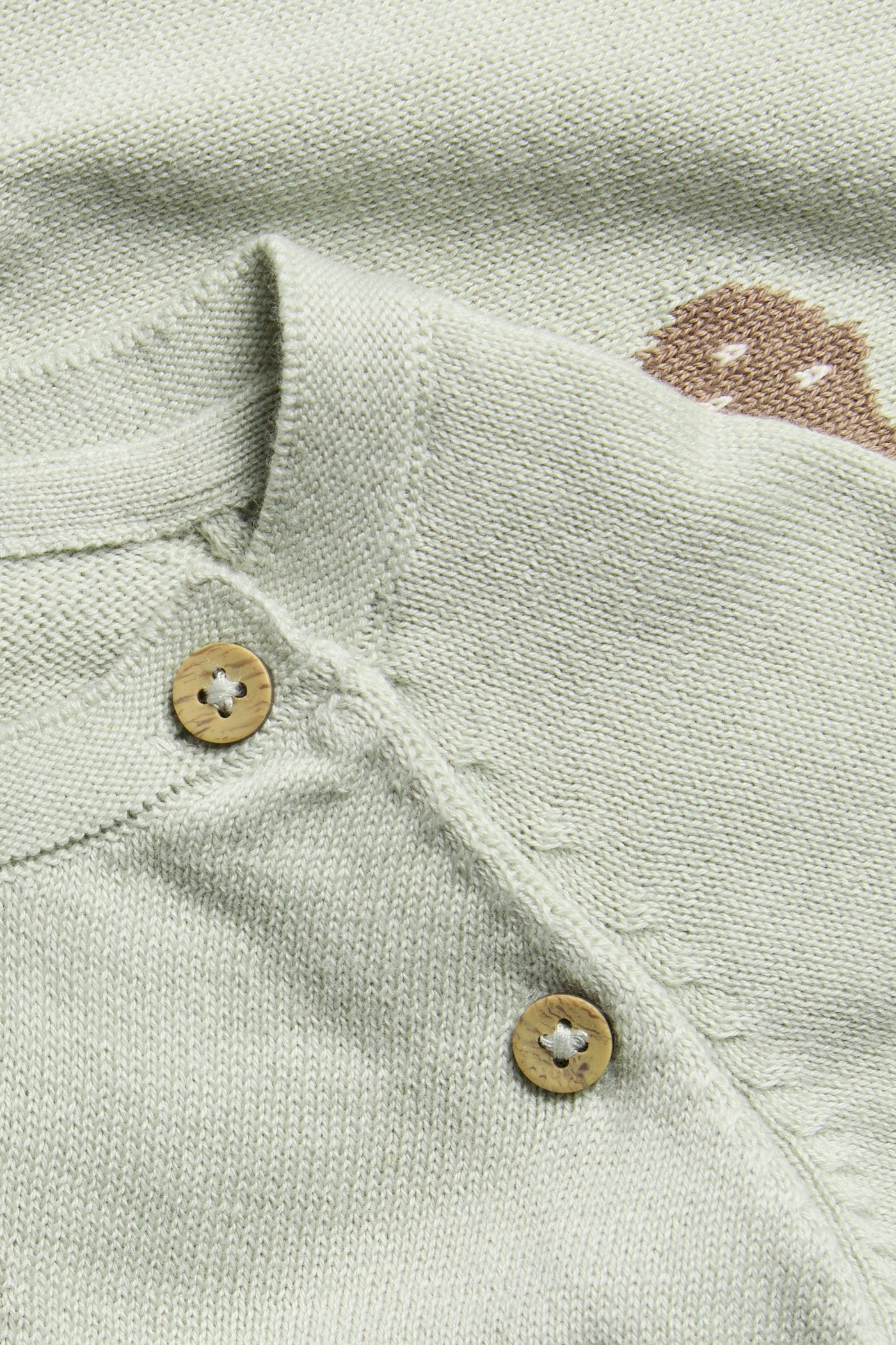 Baby green knitted cardigan with owls