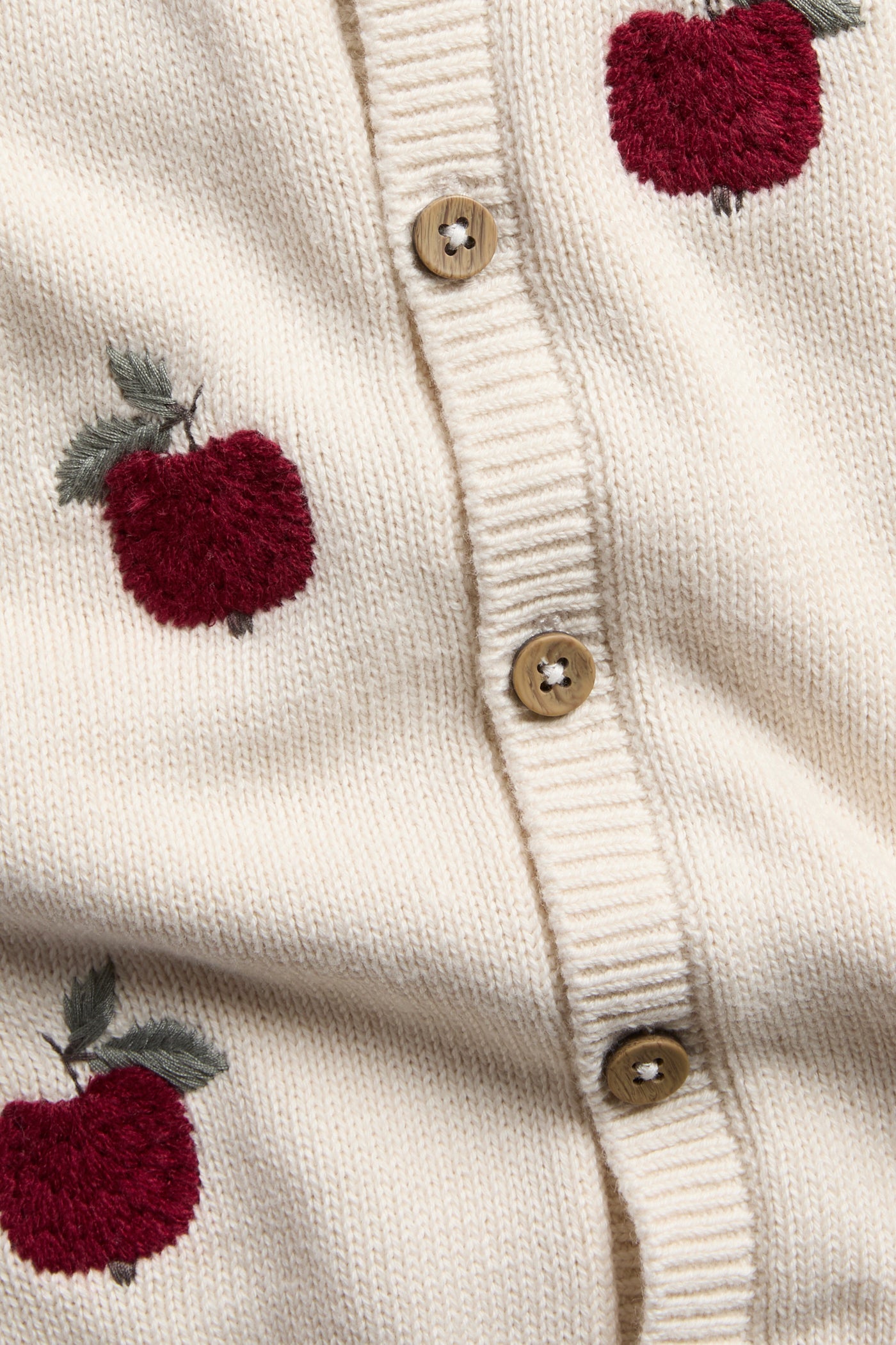 Baby beige knitted cardigan with apple