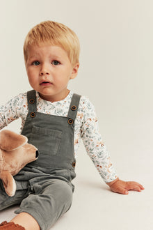 Baby white bodysuit with all-over pattern