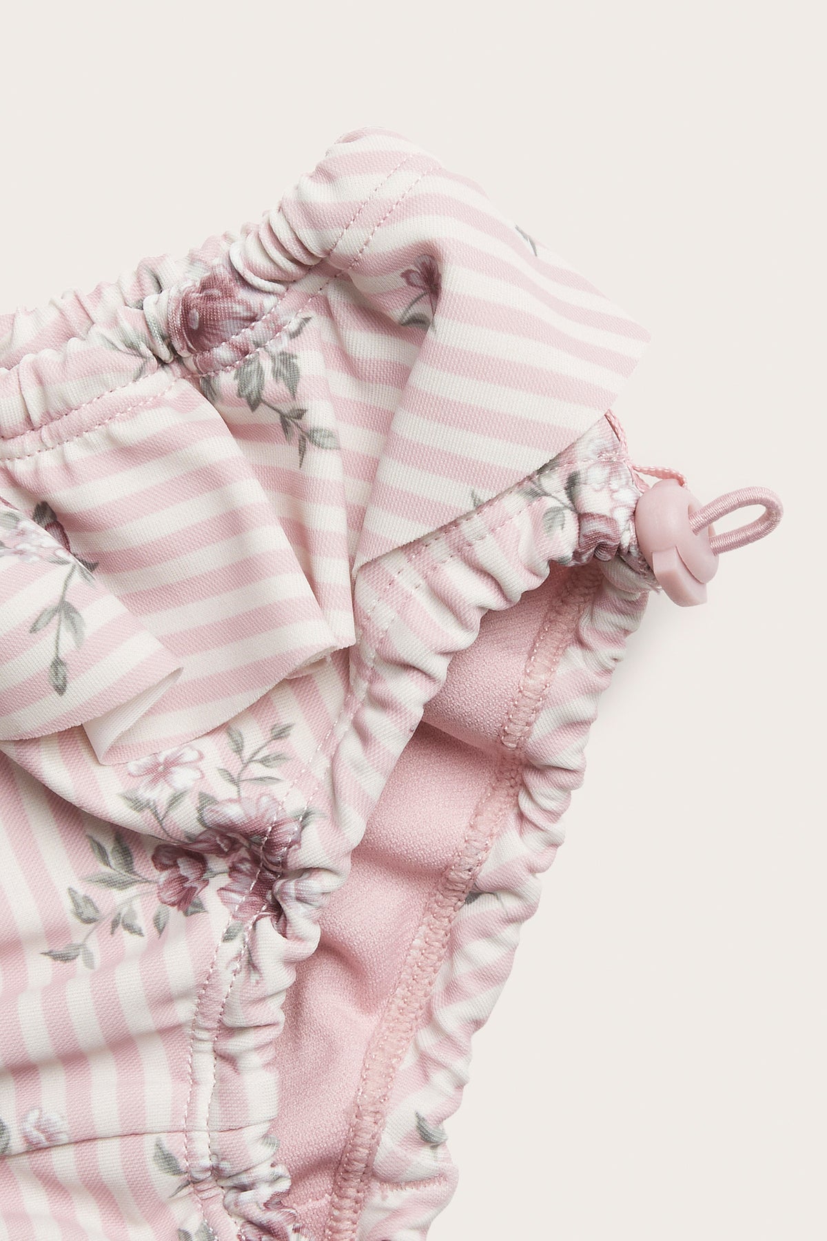 Baby pink floral swim trunks with frill