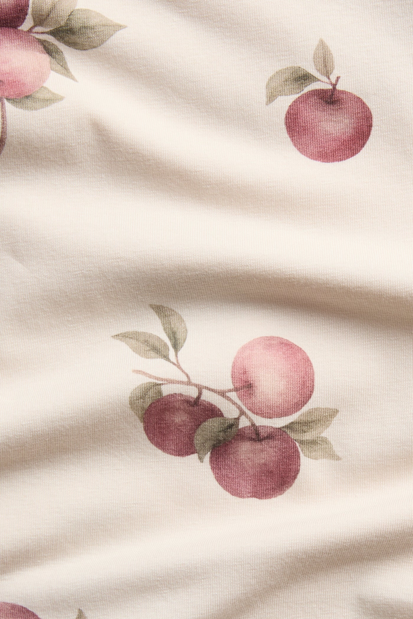 Baby beige bodysuit with apple pattern