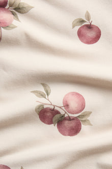 Baby beige bodysuit with apple pattern