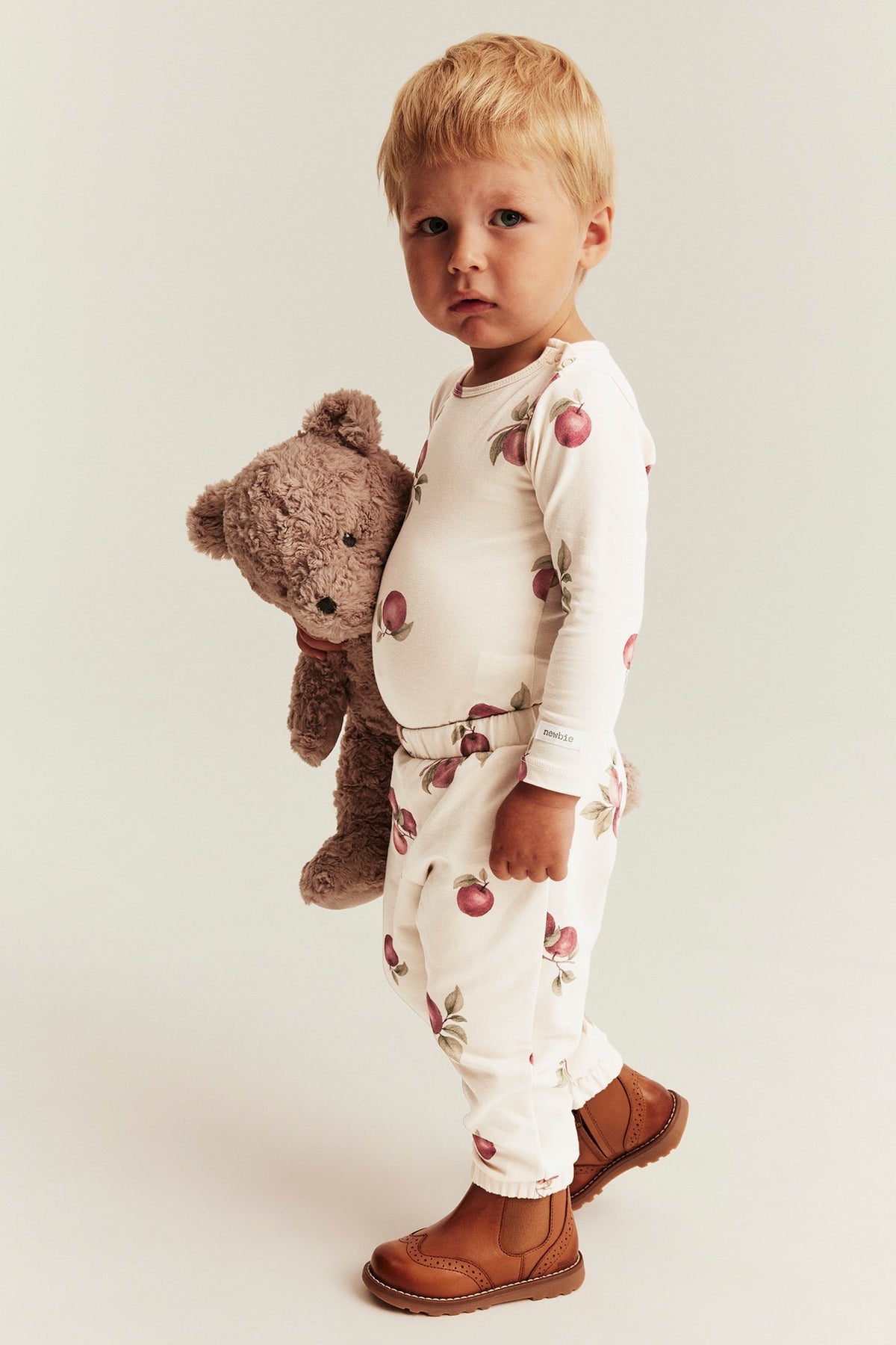Baby beige bodysuit with apple pattern