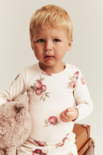 Baby beige bodysuit with apple pattern