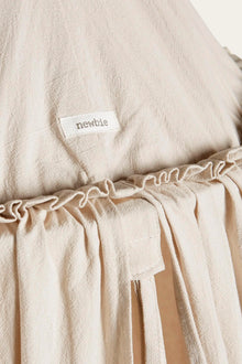 Beige reading tent with pom poms